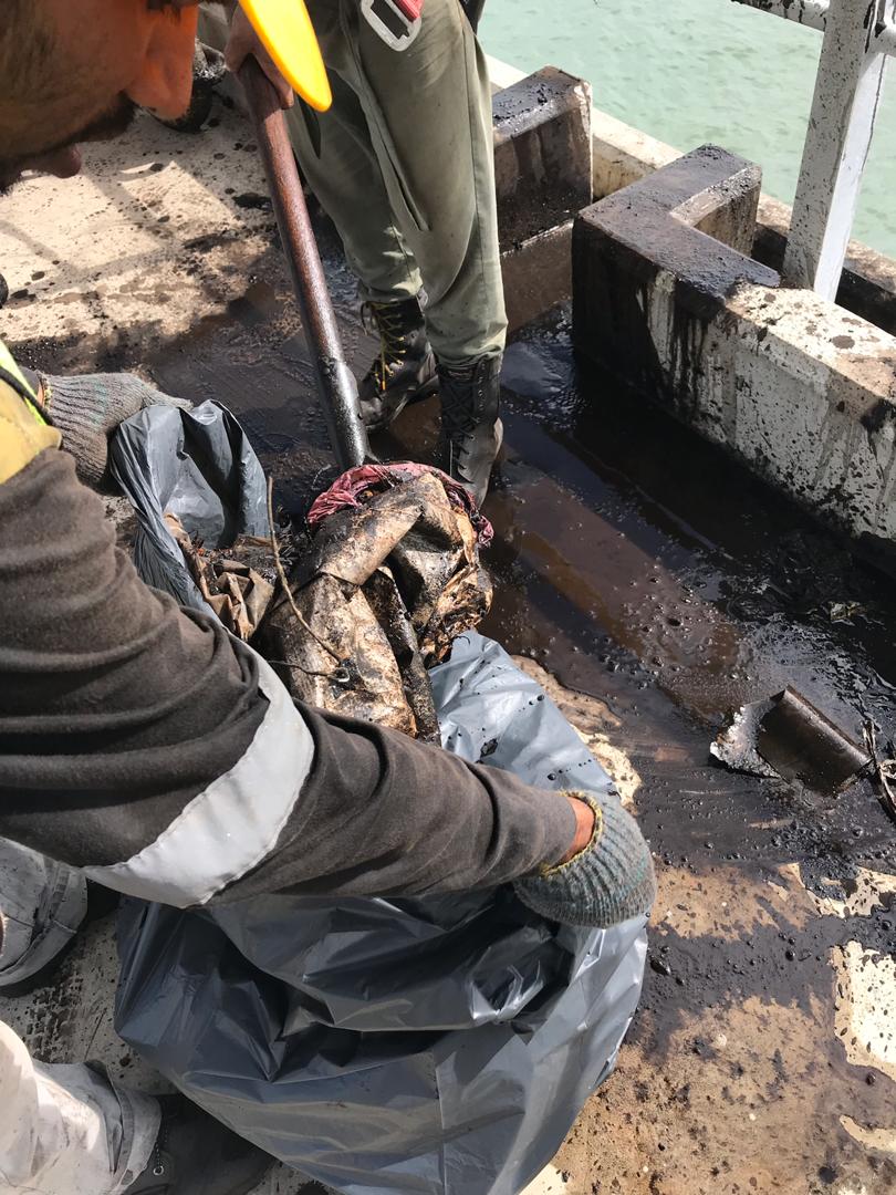 CLEANING GARBAGE INSIDE DRAIN UNDER BELT CONVEYOR LINE AREA